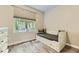 Well-lit room with a day bed, a window with great view, light colored walls and wood-look flooring at 12818 Ironstone Way # 101, Parker, CO 80134