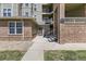 Apartment building entryway features brick accents, stair access, and clearly marked unit numbers at 12818 Ironstone Way # 101, Parker, CO 80134