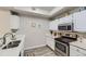 Kitchen features stainless steel appliances, white cabinetry, modern fixtures and hardware at 12818 Ironstone Way # 101, Parker, CO 80134