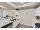 Kitchen features stainless steel appliances, modern fixtures, white cabinetry, and hardwood floors at 12818 Ironstone Way # 101, Parker, CO 80134