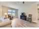 Living room with hardwood floors, modern furniture, large windows, and lots of light at 12818 Ironstone Way # 101, Parker, CO 80134