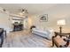 Living room with hardwood floors and an open layout to the kitchen area at 12818 Ironstone Way # 101, Parker, CO 80134