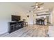 Living room with hardwood floors, ceiling fan, and open layout to the kitchen at 12818 Ironstone Way # 101, Parker, CO 80134
