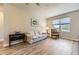 Living room features modern neutral paint, hardwood floors, and a large sunny window at 12818 Ironstone Way # 101, Parker, CO 80134
