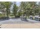 Outdoor patio area with tables, chairs, and grills, perfect for entertaining and enjoying outdoor dining with lush greenery at 12818 Ironstone Way # 101, Parker, CO 80134
