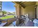 Inviting outdoor patio features a glass table, wicker seating, and a partial brick enclosure at 12818 Ironstone Way # 101, Parker, CO 80134