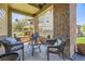 Comfortable outdoor patio featuring wicker seating, a brick partition, and a glass coffee table at 12818 Ironstone Way # 101, Parker, CO 80134