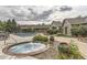 Inviting outdoor pool and spa area with lush landscaping and comfortable seating for relaxing and enjoying the community amenities at 12818 Ironstone Way # 101, Parker, CO 80134