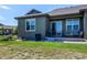 Backyard of home with green grass, a small deck, and a sliding glass door for easy access at 3375 New Haven Cir, Castle Rock, CO 80109
