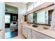 Bright bathroom with double sinks, marble countertops, a large mirror, and modern fixtures at 3375 New Haven Cir, Castle Rock, CO 80109