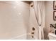 Bright white tiled bathtub and shower combination with neutral shower curtain at 3375 New Haven Cir, Castle Rock, CO 80109