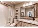 Modern bathroom featuring a shower-tub combo, a vanity with a mirror, and neutral tones at 3375 New Haven Cir, Castle Rock, CO 80109