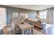 Combined dining and living area with hardwood floors, modern decor, and abundant natural light at 3375 New Haven Cir, Castle Rock, CO 80109
