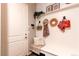 Bright entryway featuring white walls, coat hooks, bench and a sidelight at 3375 New Haven Cir, Castle Rock, CO 80109