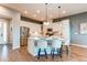 Bright, modern kitchen with stainless steel appliances, white cabinetry, and a large center island at 3375 New Haven Cir, Castle Rock, CO 80109