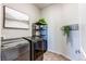 Modern laundry room with dark washer and dryer, dark shelving and neutral walls at 3375 New Haven Cir, Castle Rock, CO 80109