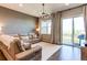 Bright living room with hardwood floors, modern chandelier, and sliding glass doors to the balcony at 3375 New Haven Cir, Castle Rock, CO 80109