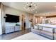 Stylish living room featuring a TV, modern decor, and an open layout leading to the kitchen at 3375 New Haven Cir, Castle Rock, CO 80109