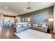 Open-concept living room showcasing a leather sectional, modern chandelier, and adjacent kitchen with bar seating at 3375 New Haven Cir, Castle Rock, CO 80109