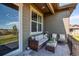 Relaxing patio with cushioned wicker seating, patterned rug, and view at 3375 New Haven Cir, Castle Rock, CO 80109