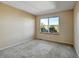 Bright bedroom featuring neutral walls, carpet, and a window providing natural light at 812 Union St # B, Lakewood, CO 80401