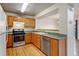 Functional kitchen with wood cabinets, stainless steel appliances, and green countertops providing a practical cooking space at 812 Union St # B, Lakewood, CO 80401