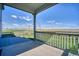Covered porch showcasing outdoor space with scenic views of the lawn and distant mountains at 5805 Red Barn Ave, Mead, CO 80504