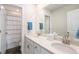 Bright bathroom featuring double sinks, a large mirror, white countertops, and a shower with a curtain at 5805 Red Barn Ave, Mead, CO 80504