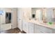 Bright bathroom with double vanity sinks and modern fixtures and a glass enclosed shower at 5805 Red Barn Ave, Mead, CO 80504