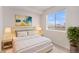 Inviting bedroom featuring a bright window, modern art, and plush decor at 5805 Red Barn Ave, Mead, CO 80504