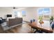 Open-concept dining area with ample natural light and stylish modern furniture at 5805 Red Barn Ave, Mead, CO 80504