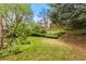 Backyard with mature trees and lawn with tiered landscaping at 6602 S Vance St, Littleton, CO 80123
