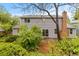 The backyard features a patio, brick fireplace, and lush landscaping at 6602 S Vance St, Littleton, CO 80123