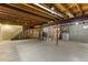 Unfinished basement with concrete walls, exposed wood ceiling, and a washer and dryer at 6602 S Vance St, Littleton, CO 80123