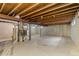 Unfinished basement with exposed beams and concrete walls at 6602 S Vance St, Littleton, CO 80123
