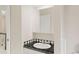 The bathroom has a white vessel sink and a black and white tiled counter at 6602 S Vance St, Littleton, CO 80123