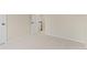A bright and airy room featuring neutral carpet and view of the upstairs area at 6602 S Vance St, Littleton, CO 80123