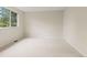 This light-filled, carpeted room features a large window and neutral walls, creating a bright atmosphere at 6602 S Vance St, Littleton, CO 80123