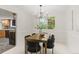 Bright dining room featuring a modern chandelier and a view of the backyard at 6602 S Vance St, Littleton, CO 80123