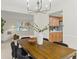 Open concept dining room showcasing modern lighting, leading into the living area and kitchen at 6602 S Vance St, Littleton, CO 80123