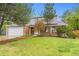 Charming two-story home with brick and siding exterior, landscaped yard, and attached garage at 6602 S Vance St, Littleton, CO 80123
