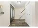 Welcoming foyer with tile floors, coat closet, and staircase leading to the upper level at 6602 S Vance St, Littleton, CO 80123