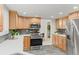 Spacious kitchen showcasing stainless steel appliances, granite countertops, and tile floors at 6602 S Vance St, Littleton, CO 80123