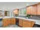 Beautiful kitchen featuring stone countertops, custom cabinets, and modern appliances at 6602 S Vance St, Littleton, CO 80123