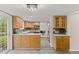 Bright kitchen features wood cabinets, tile floors, and stainless steel appliances at 6602 S Vance St, Littleton, CO 80123
