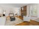 Cozy living room with a brick fireplace, hardwood floors, and plantation shutters at 6602 S Vance St, Littleton, CO 80123