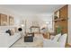 Bright living room features a brick fireplace, neutral decor, and hardwood floors at 6602 S Vance St, Littleton, CO 80123