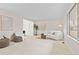 Bright and airy living room featuring neutral decor, large windows, and comfortable seating at 6602 S Vance St, Littleton, CO 80123