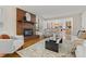 Open living room with fireplace, hardwood floors, and seamless transition to the kitchen at 6602 S Vance St, Littleton, CO 80123