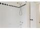 Clean shower features white tile and black accent tile at 6602 S Vance St, Littleton, CO 80123